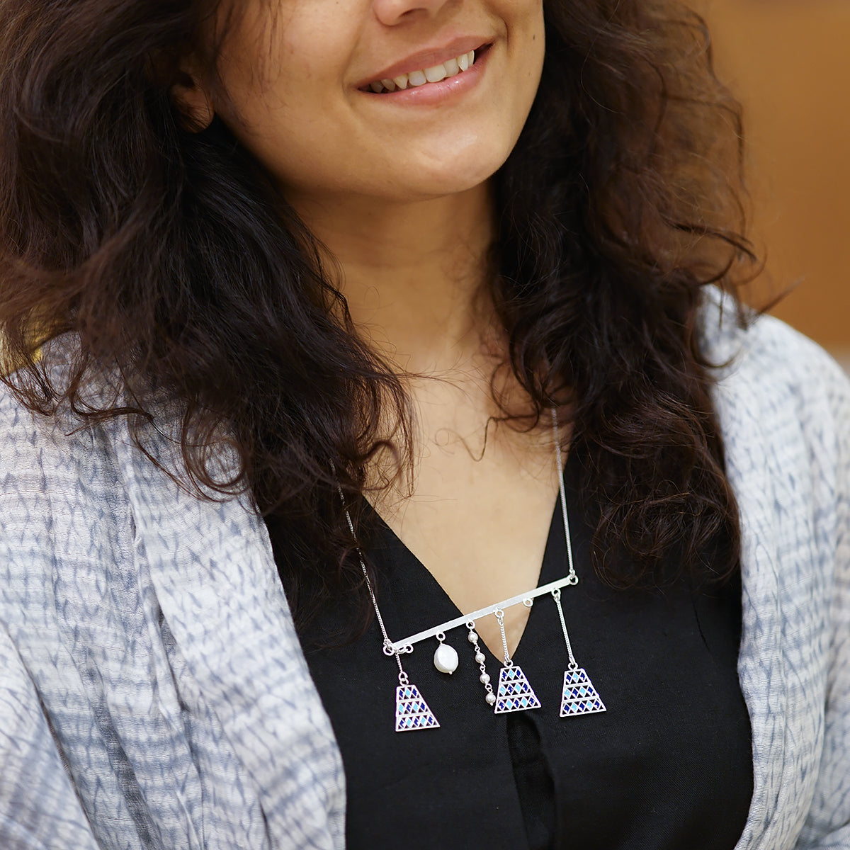 a woman wearing a black shirt and a necklace