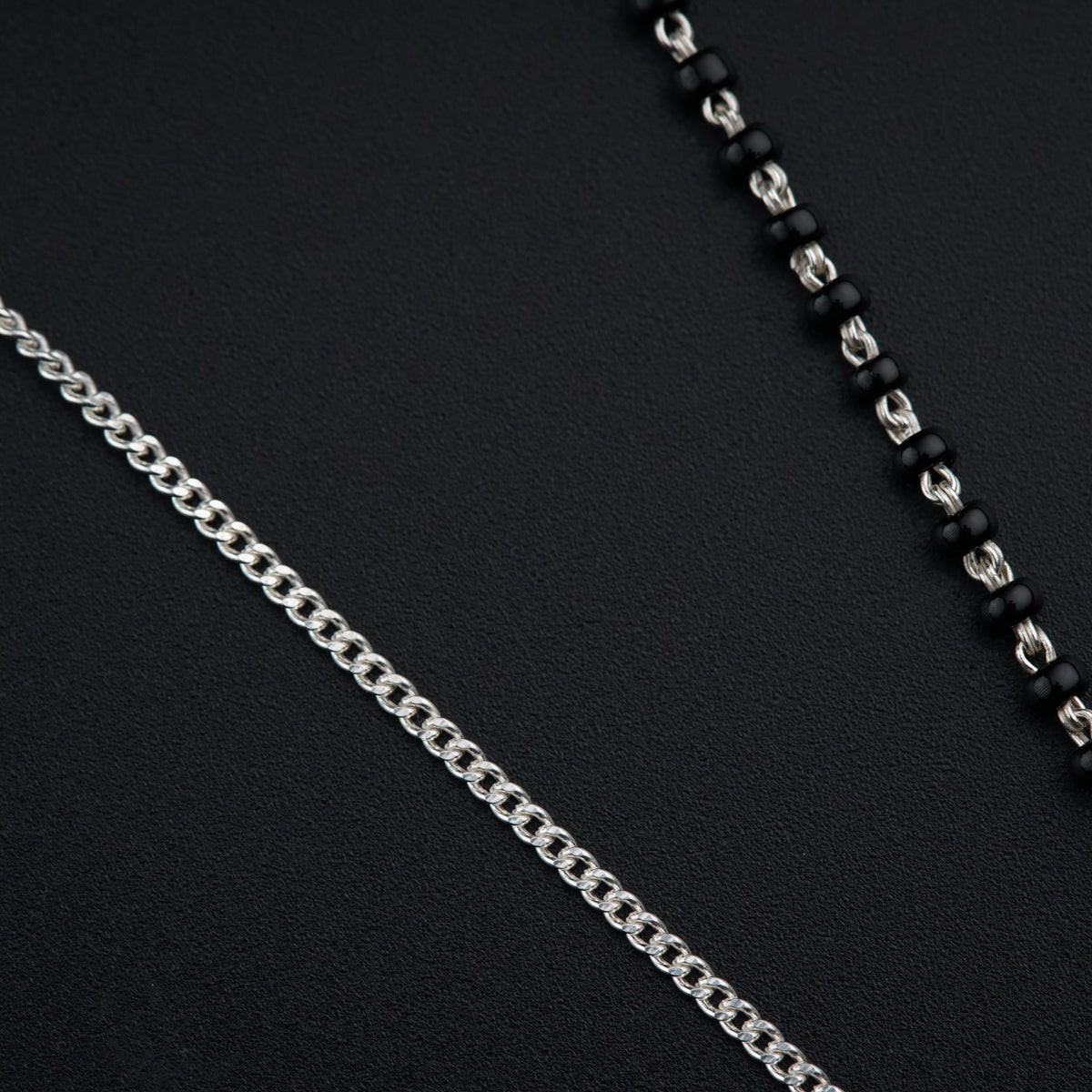 a black and silver necklace with a chain attached to it