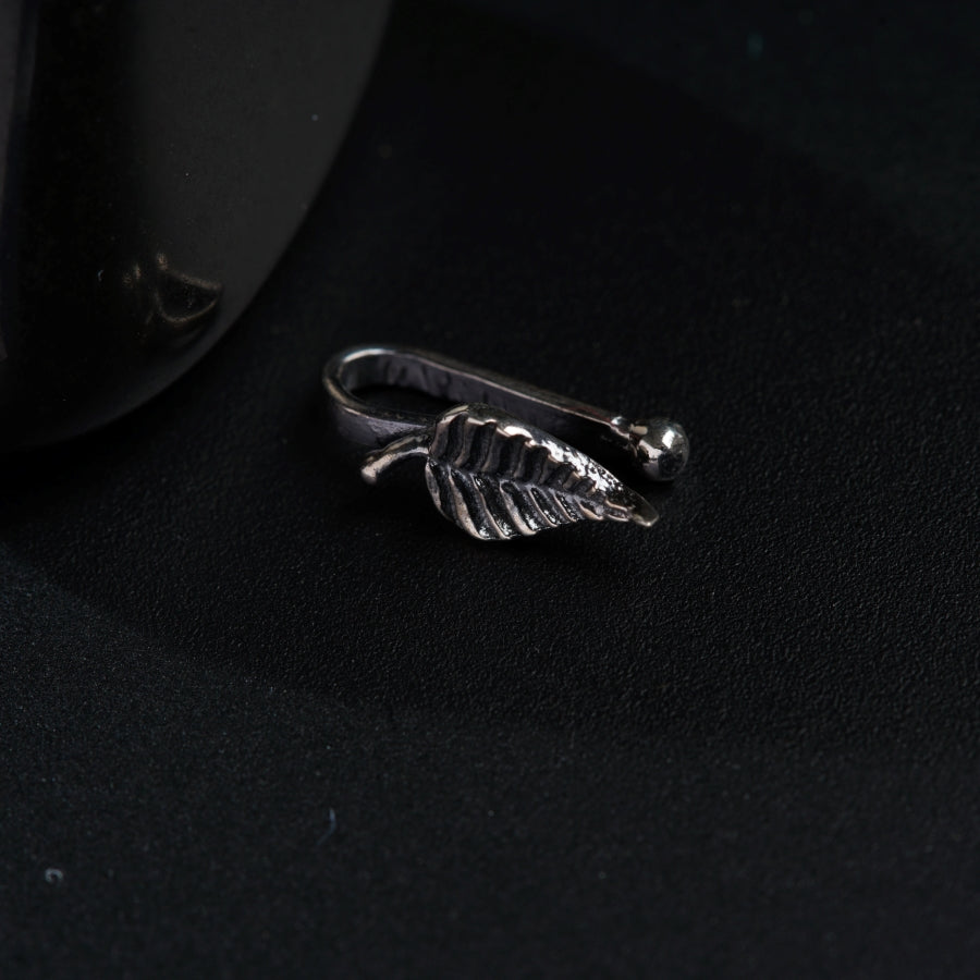a silver ring with a leaf on it