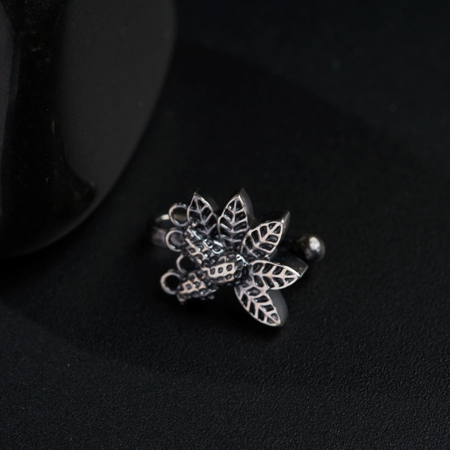 a silver ring with a flower design on it