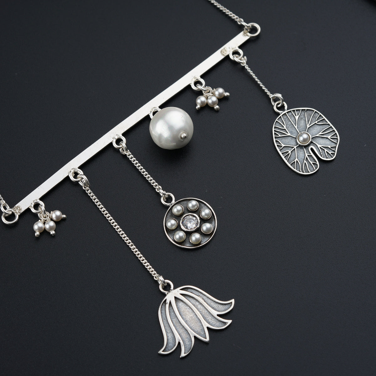 a close up of a necklace on a black surface