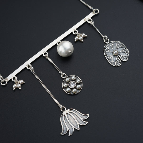 a close up of a necklace on a black surface
