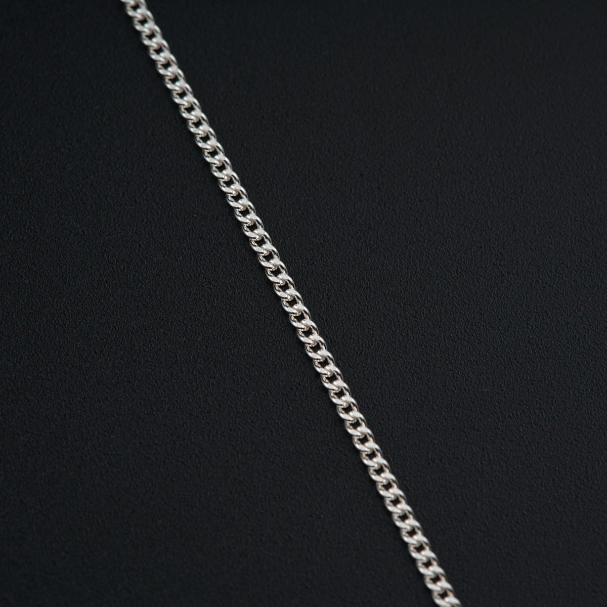 a silver chain on a black background