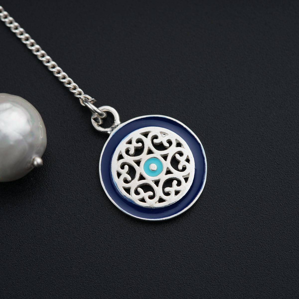 a necklace with a blue and white design on it