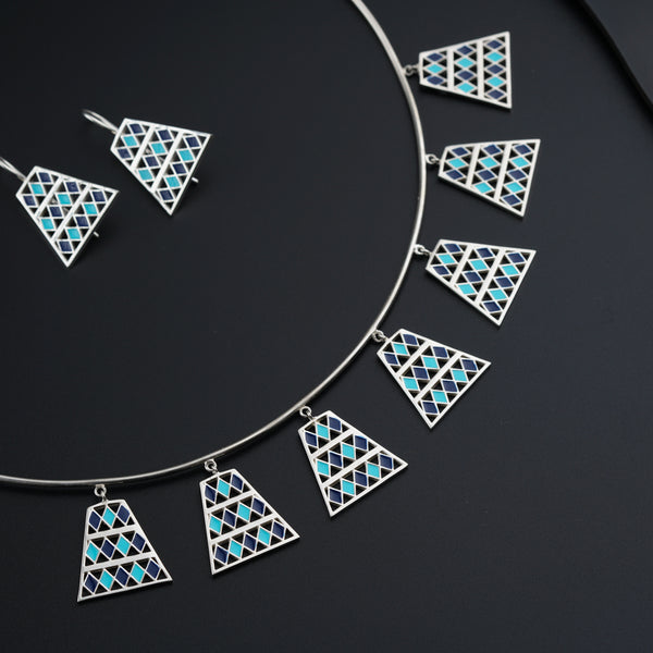 a necklace and earring set with blue and white triangles