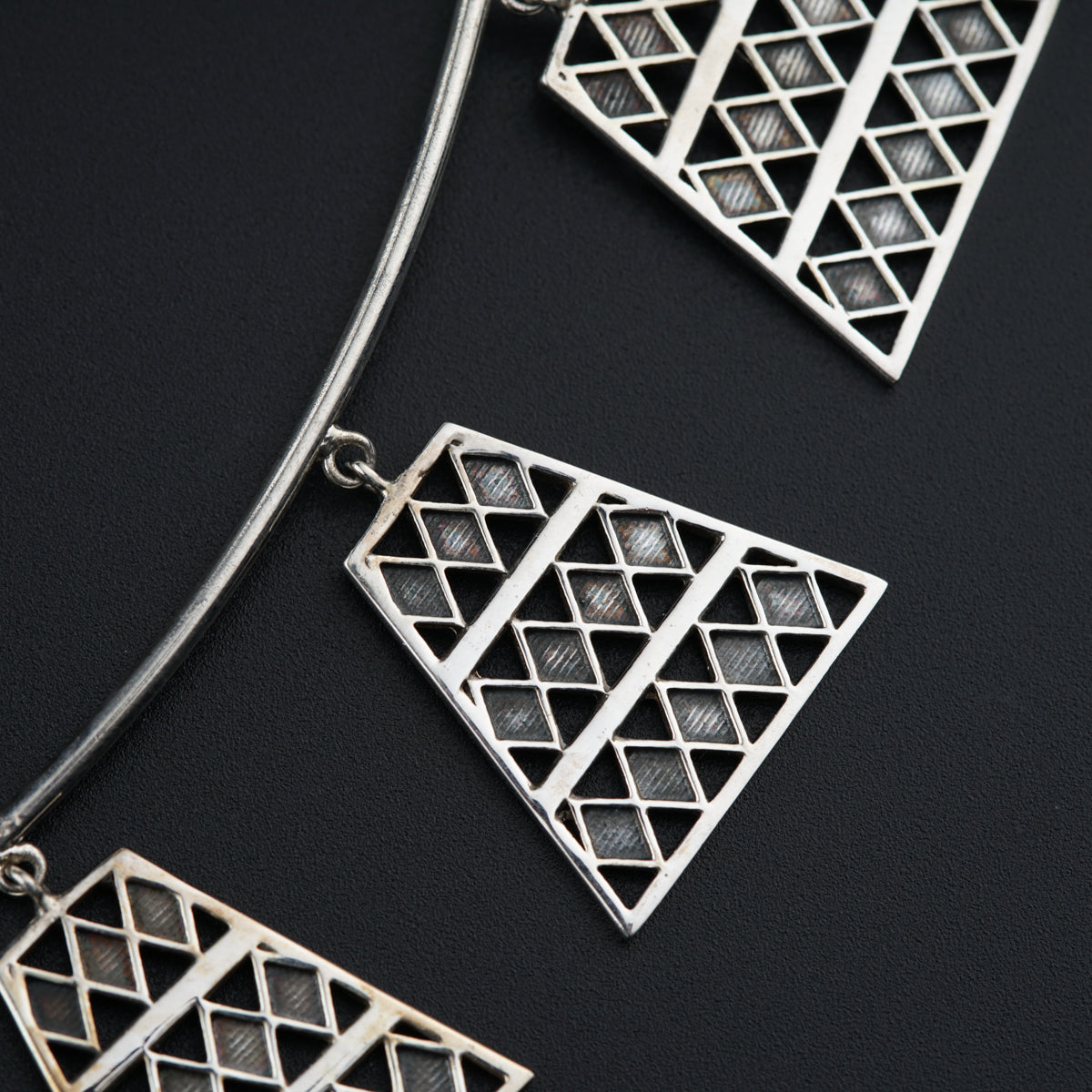 a close up of a necklace on a black surface