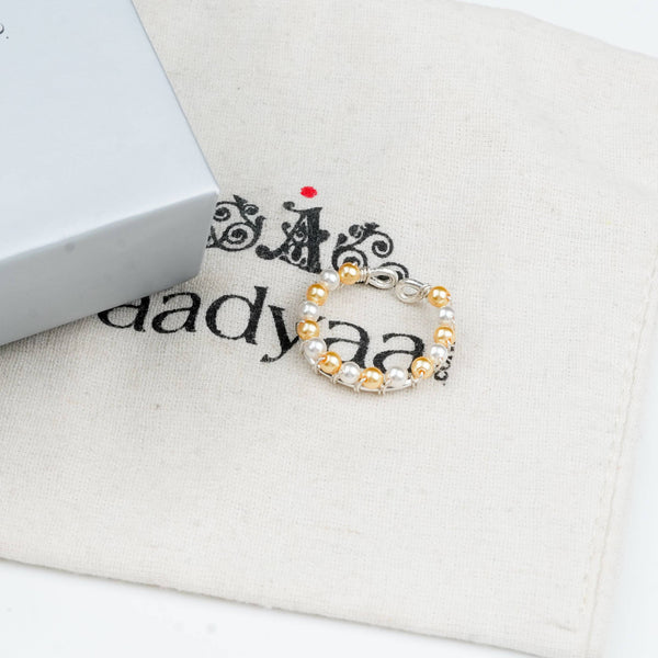 Sterling silver ring with golden and white pearl detailing
