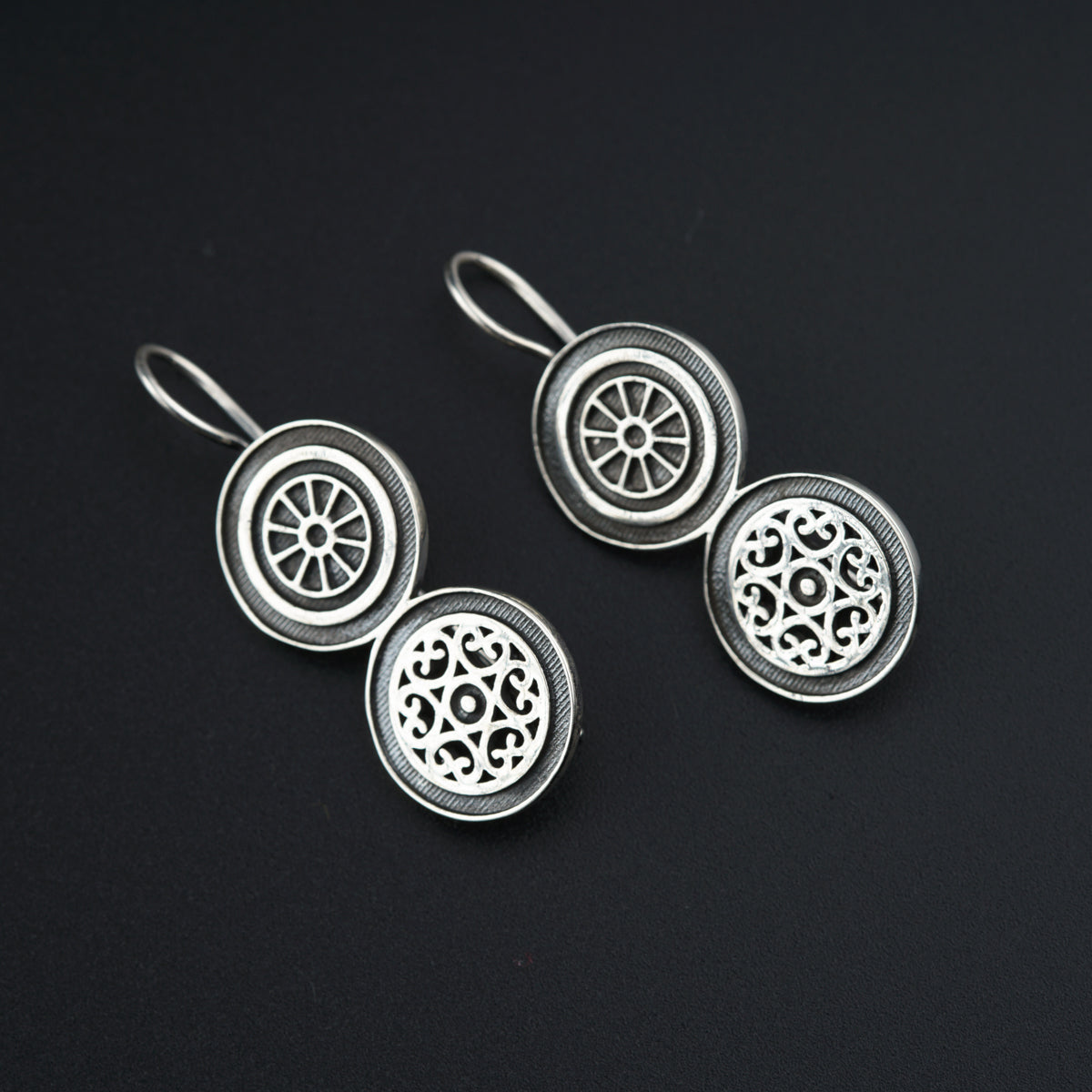 a pair of earrings sitting on top of a table