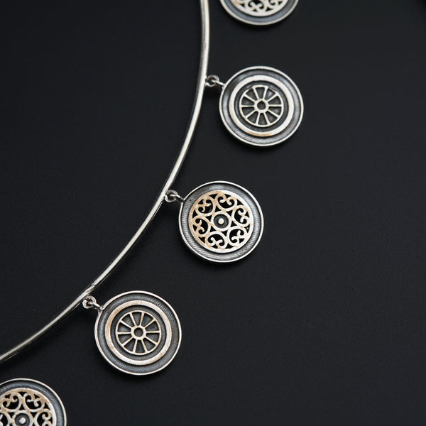 a close up of a necklace on a black surface