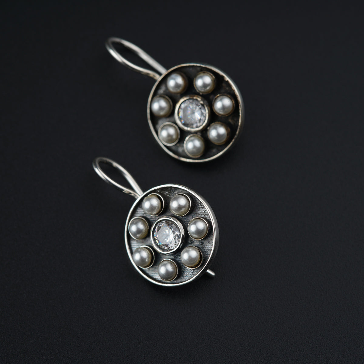 a pair of earrings sitting on top of a table
