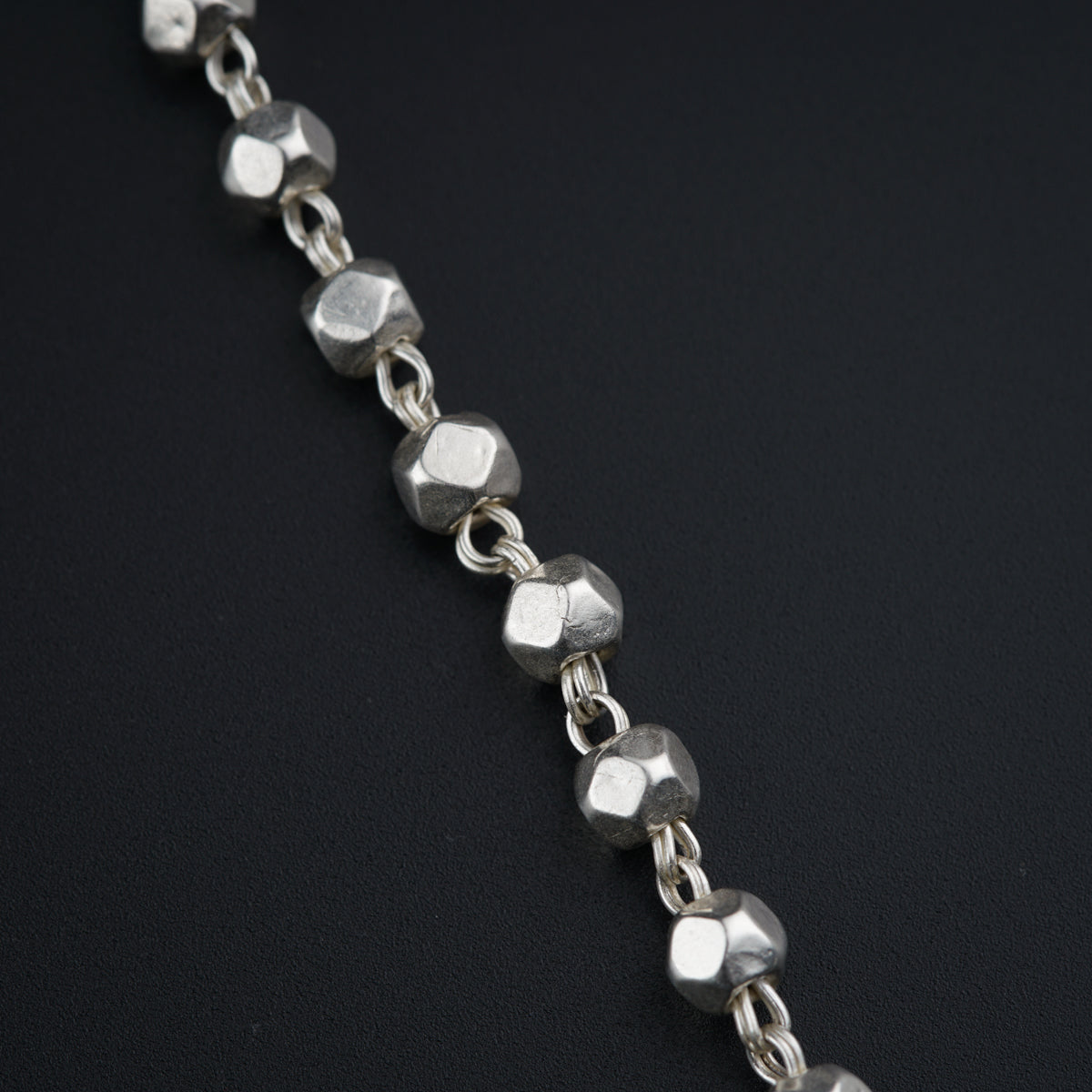 a close up of a chain on a black surface