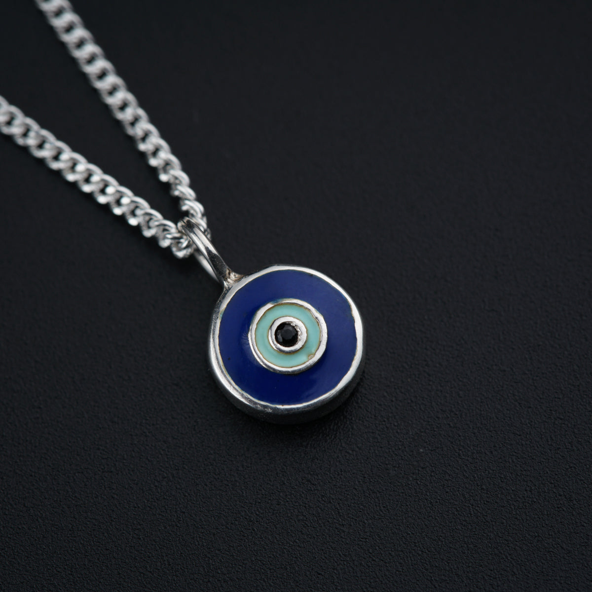 a necklace with a blue evil eye on it