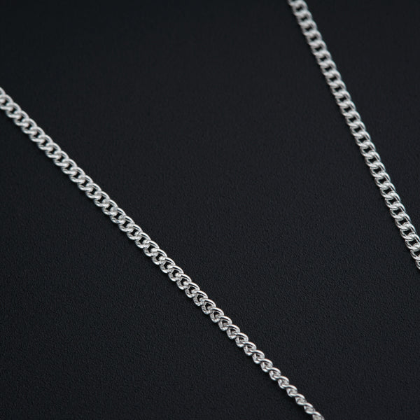a close up of a chain on a black surface