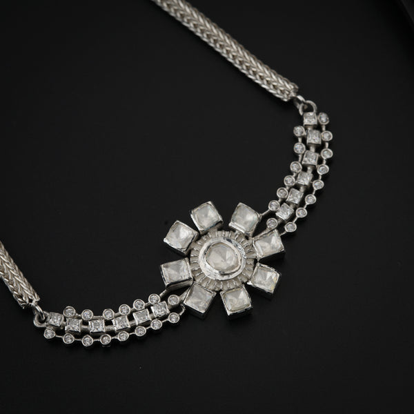 Close-up of silver jewelry with floral moissanite stones