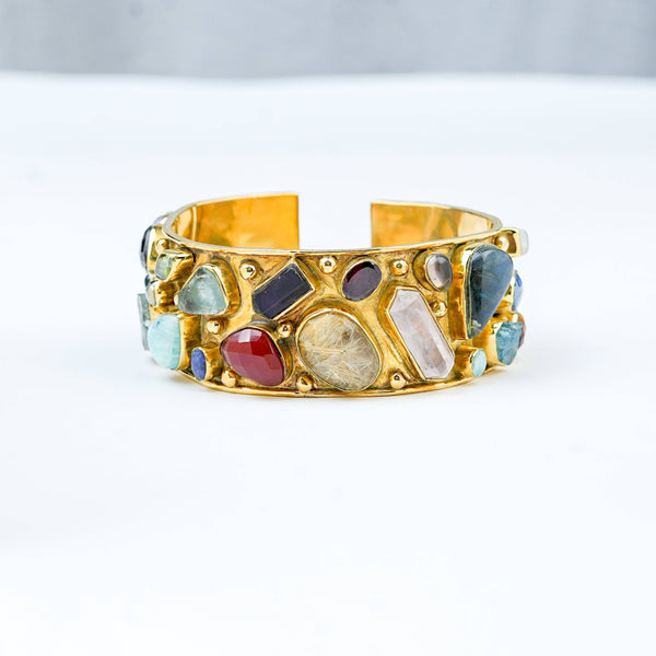 Detailed view of a brass fashion bracelet highlighting intricate motifs, textured surface, and refined brass finish