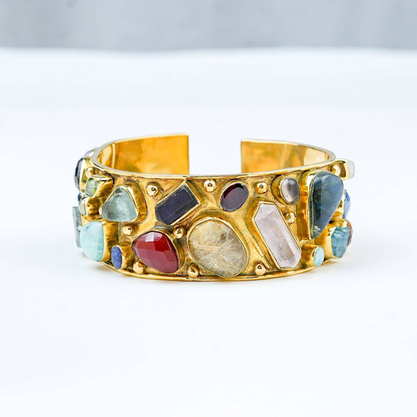 Close-up of a brass fashion bracelet showcasing intricate detailing, textured elements, and fine craftsmanship