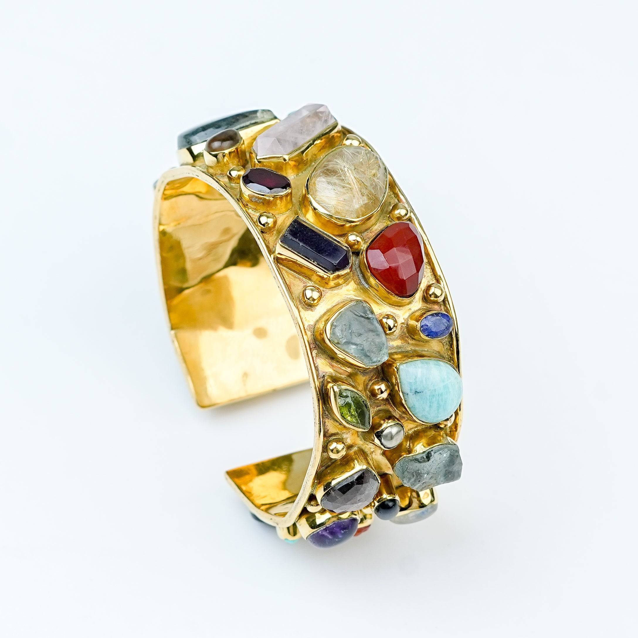 Angled view of a brass fashion bracelet highlighting its unique silhouette, structure, and polished brass finish