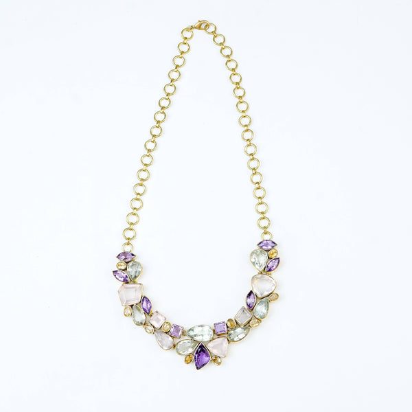 Detailed view of a brass fashion necklace highlighting intricate motifs, textured surface, and refined brass finish