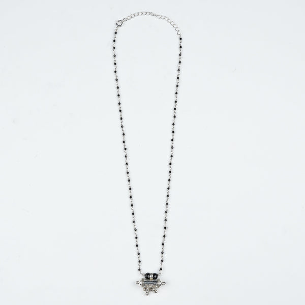 Flat-lay of Black Spinel Ganthan Necklace with Tait Pendant with traditional accessories and elegant festive styling