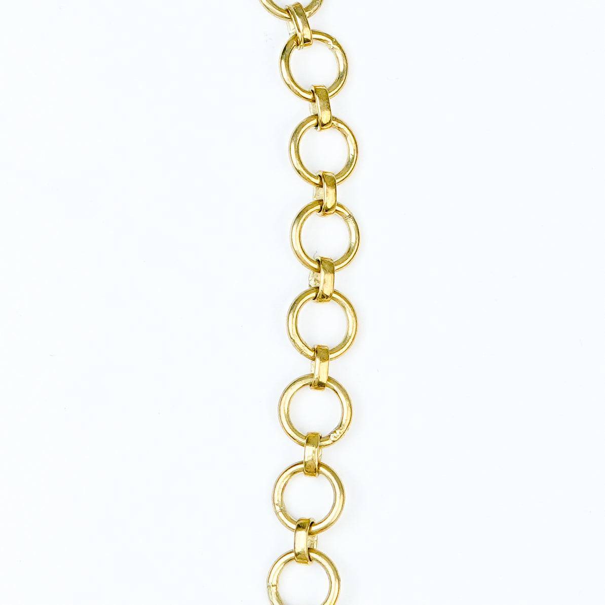 Flat-lay of a brass fashion necklace with complementary jewellery and accessories for a chic styling setup