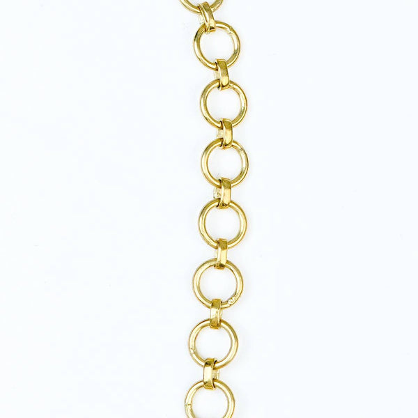 Flat-lay of a brass fashion necklace with complementary jewellery and accessories for a chic styling setup