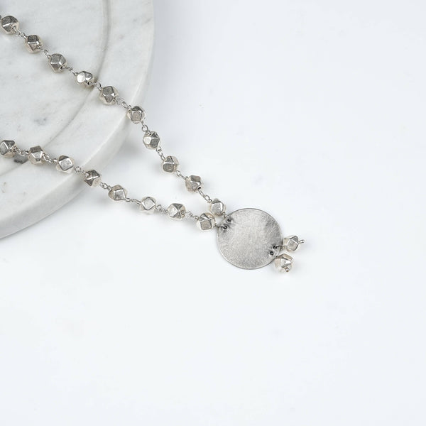Angled view of Ashtapailu Necklace with Plain Coin Pendant in 92.5 sterling silver with an elegant, plain coin pendant