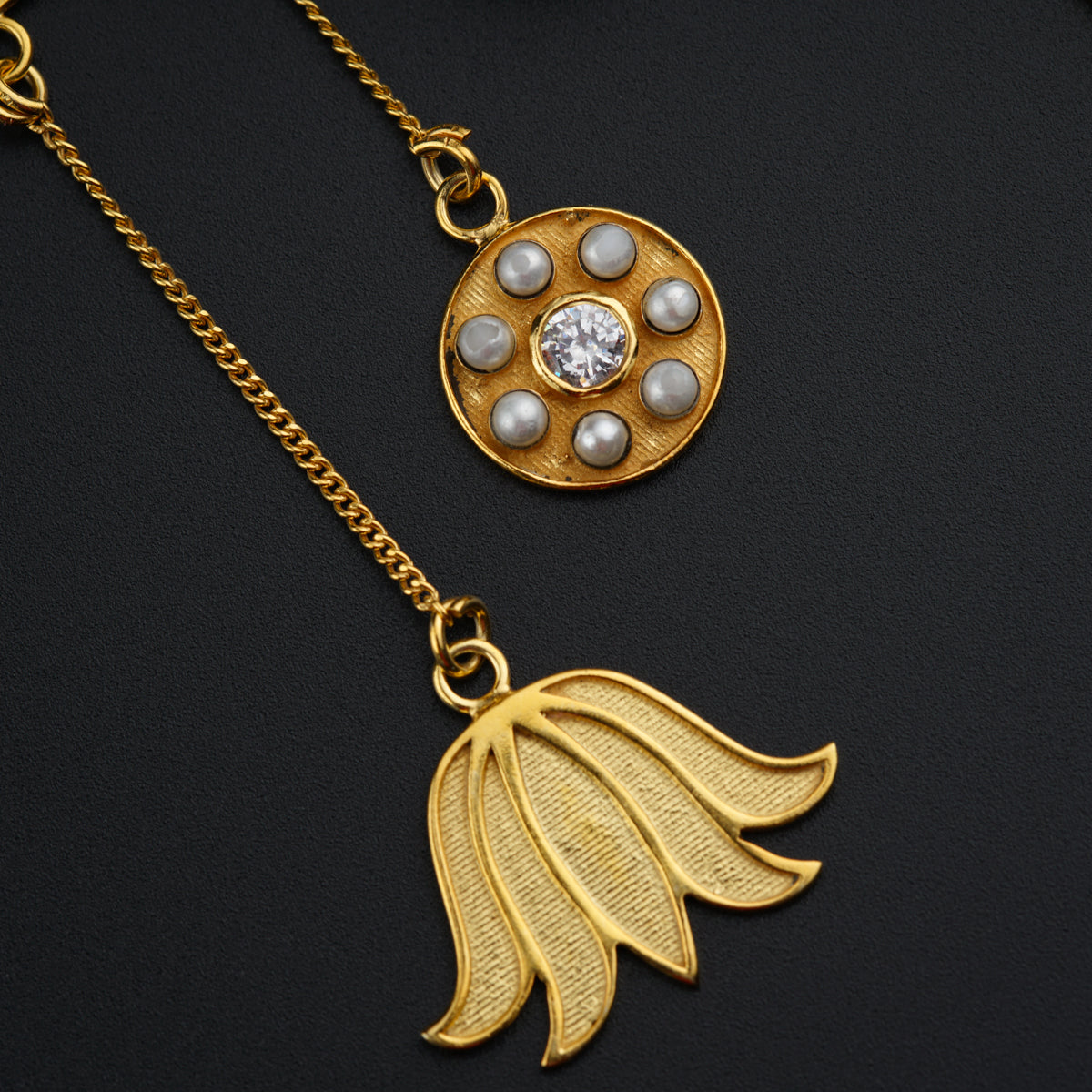 a close up of two necklaces on a black surface