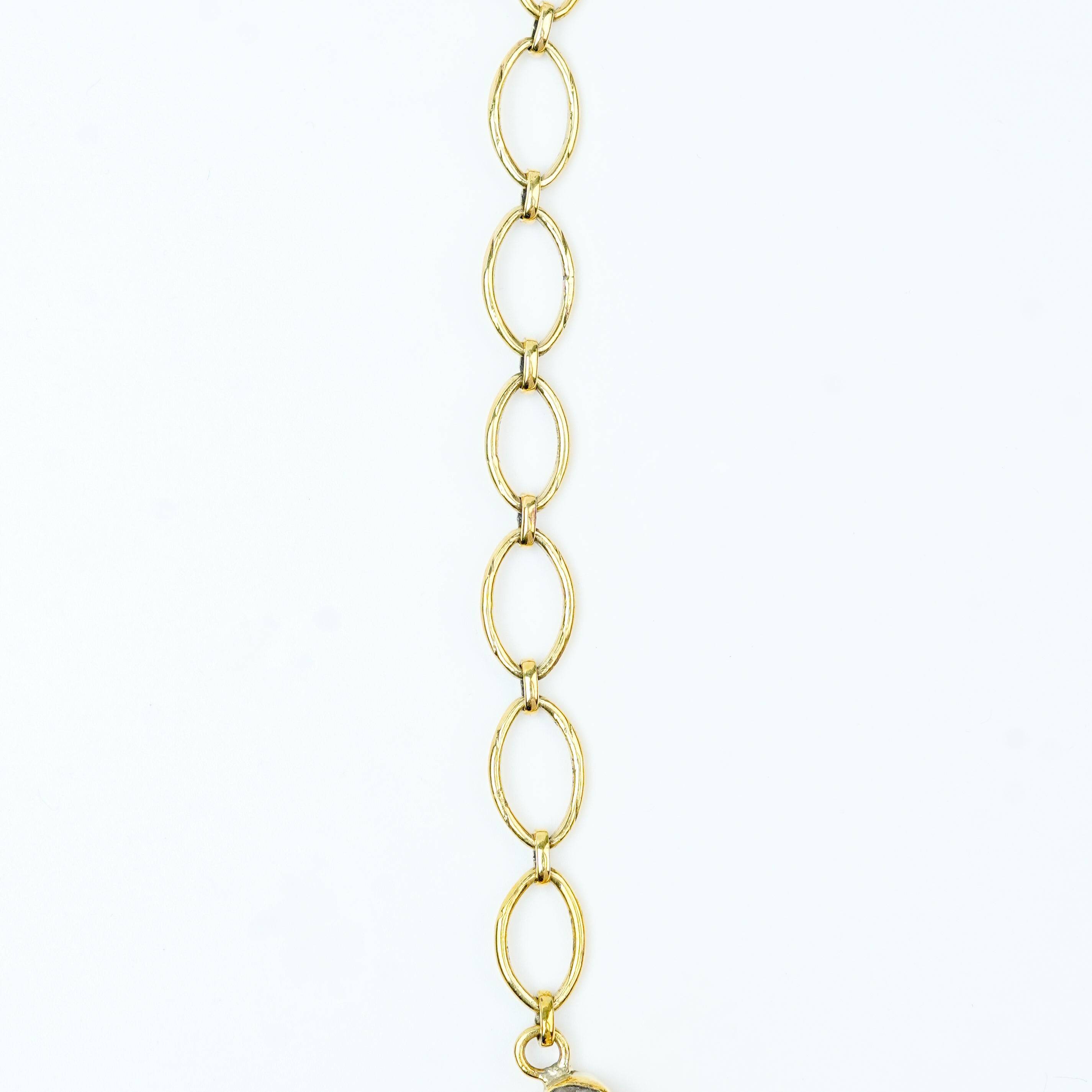 Flat-lay of a brass fashion necklace with complementary jewellery and accessories for a chic styling setup
