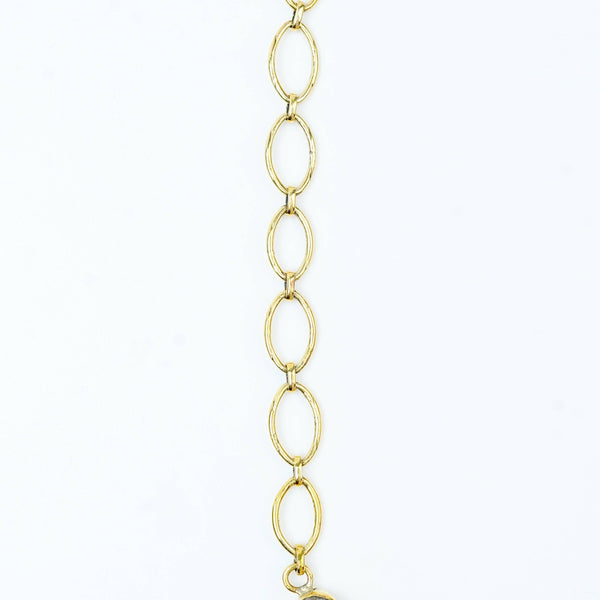 Flat-lay of a brass fashion necklace with complementary jewellery and accessories for a chic styling setup