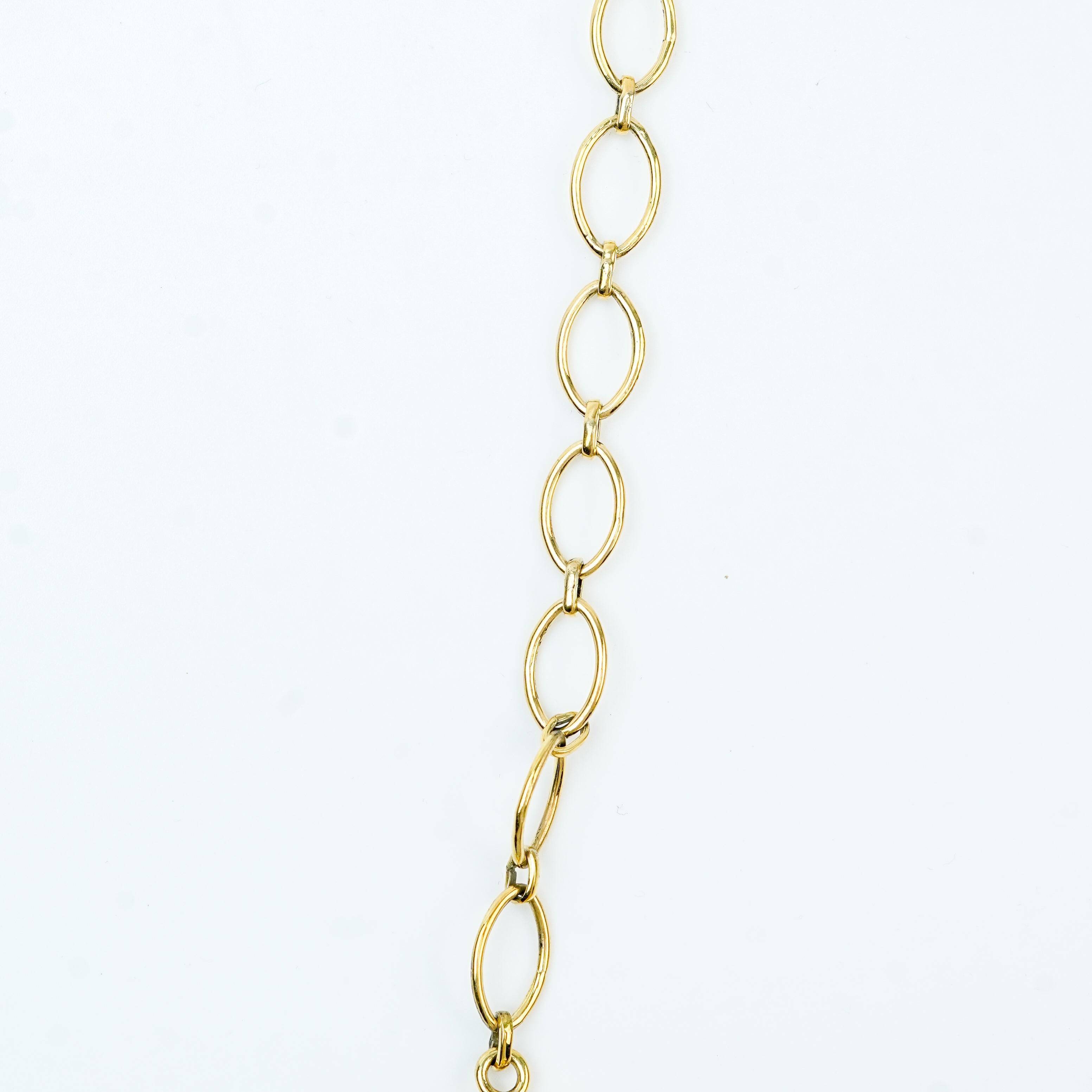 Flat-lay of a brass fashion necklace with complementary jewellery and accessories for a chic styling setup