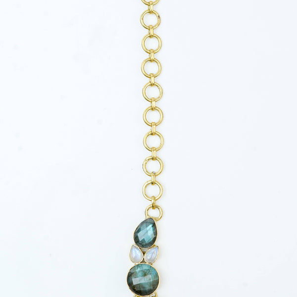 Flat-lay of a brass fashion necklace with complementary jewellery and accessories for a chic styling setup