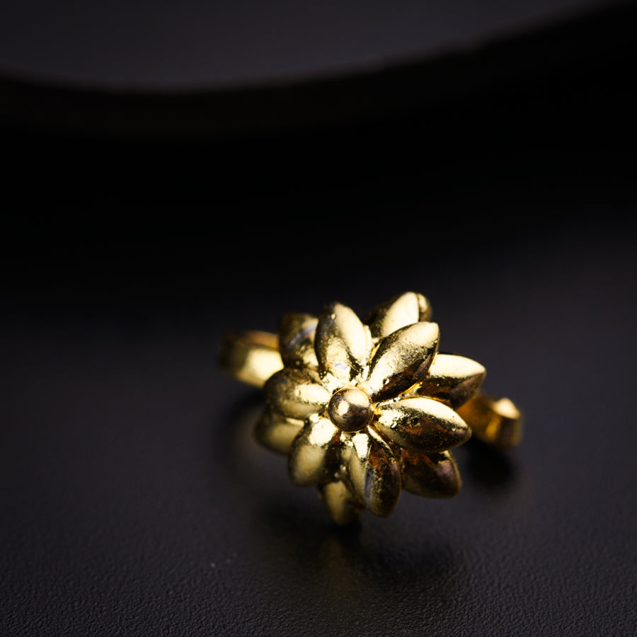 a close up of a gold ring on a black surface