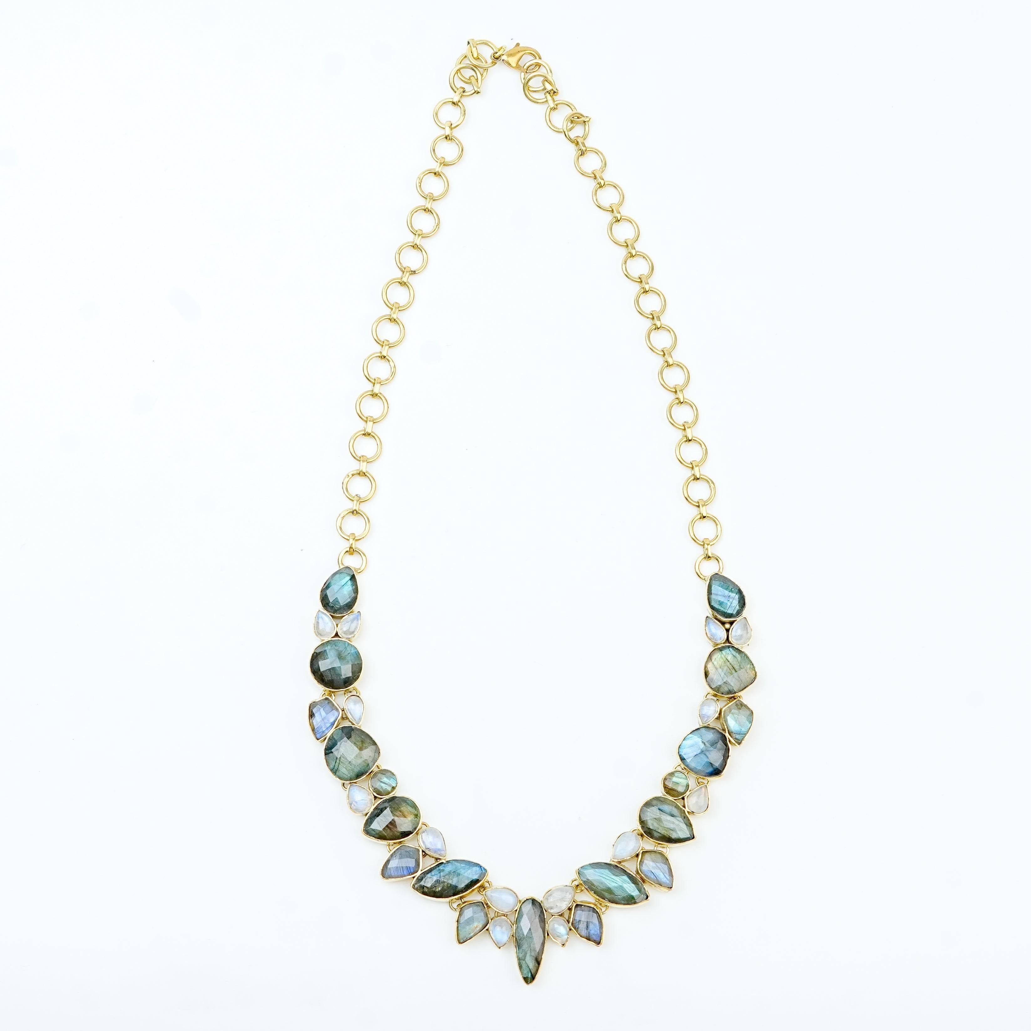 Detailed view of a brass fashion necklace highlighting intricate motifs, textured surface, and refined brass finish