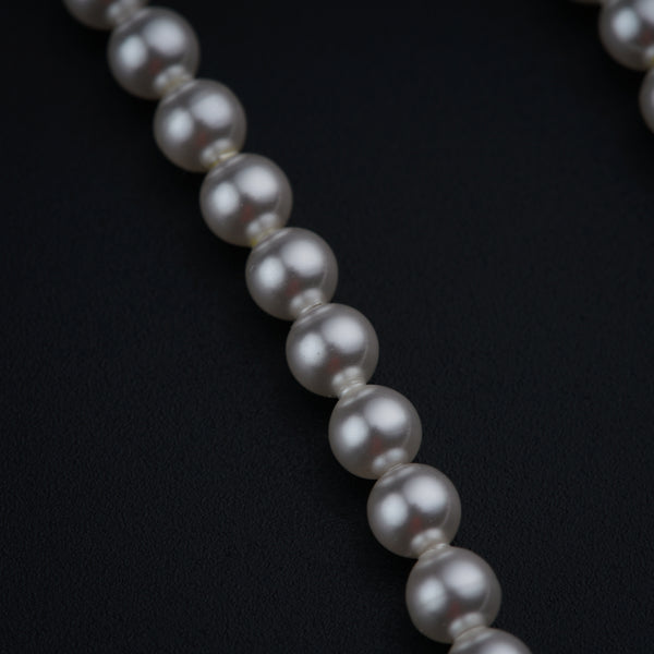 a close up of a necklace on a black surface