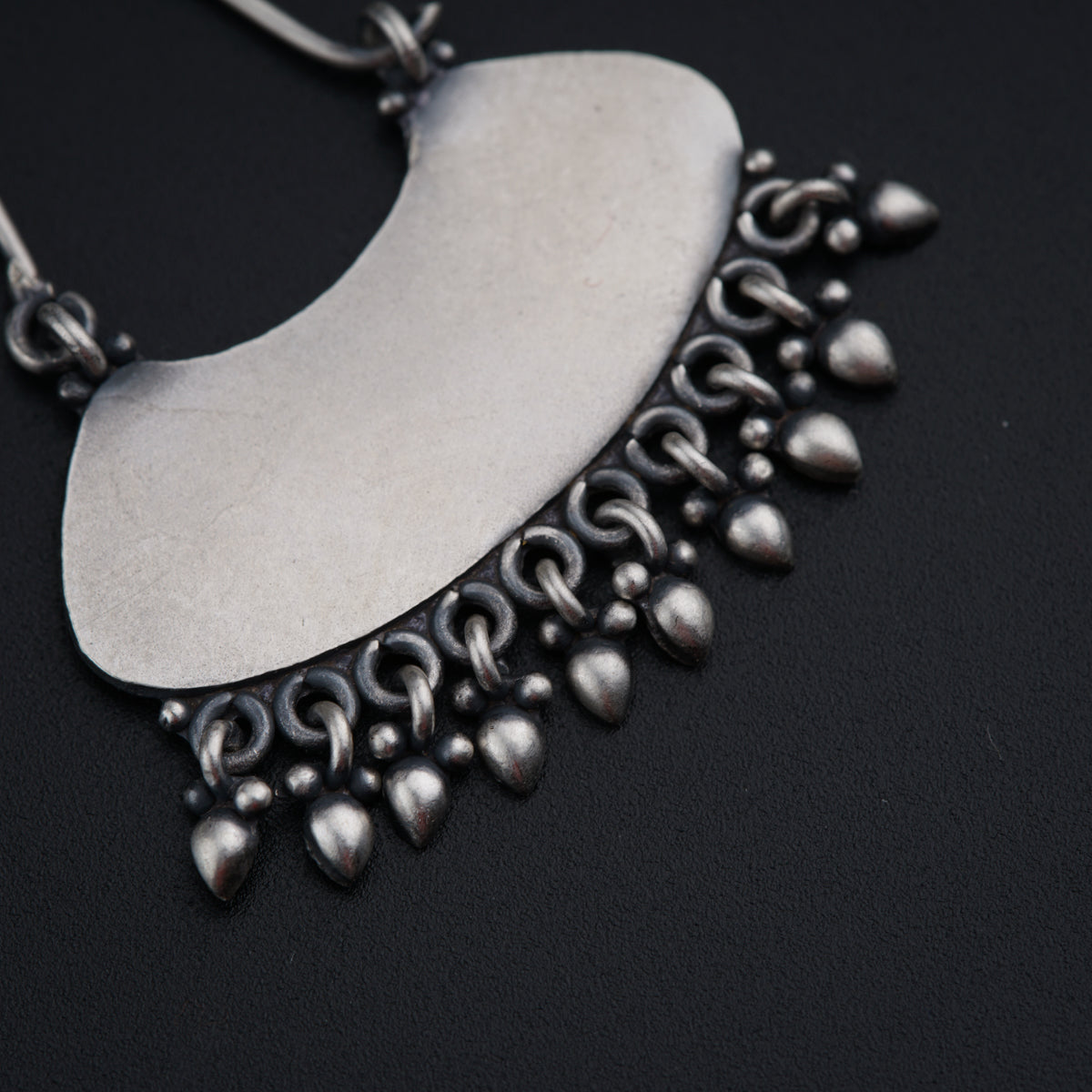 a close up of a metal object on a black surface