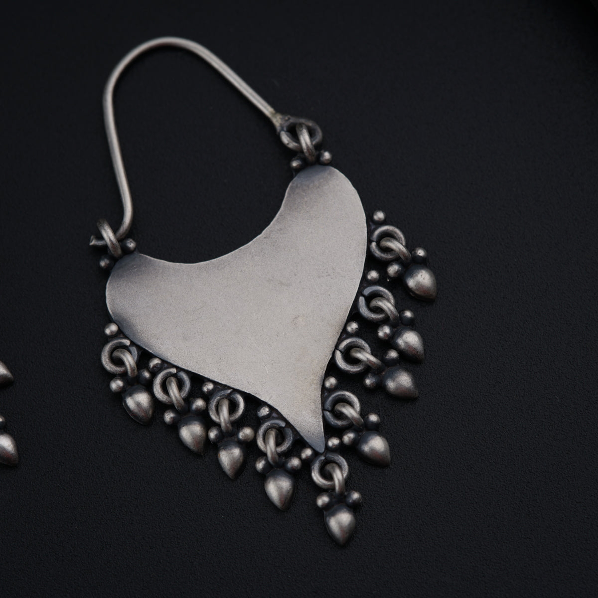 a close up of a pair of earrings on a table