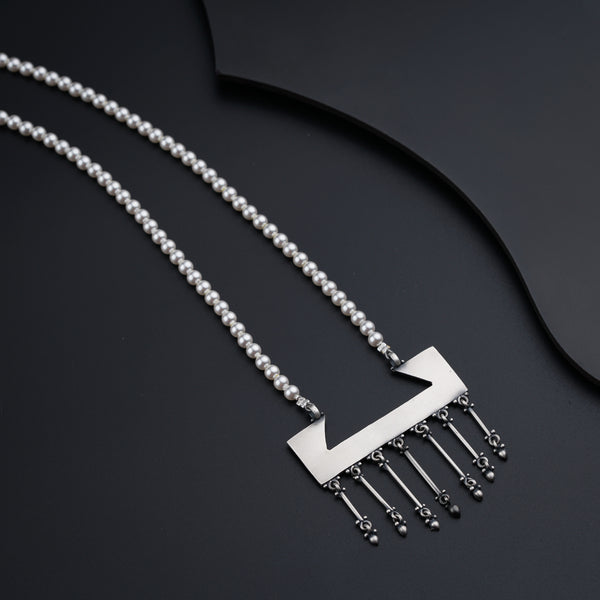 a necklace with a comb of beads hanging from it