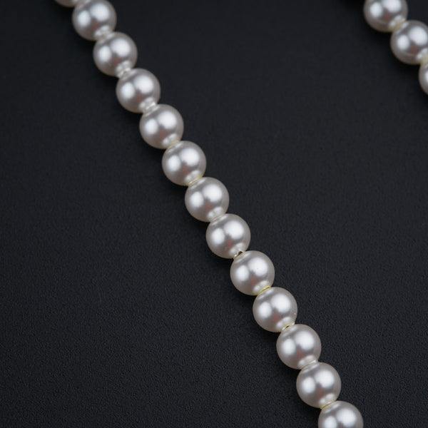 a close up of a necklace on a black surface