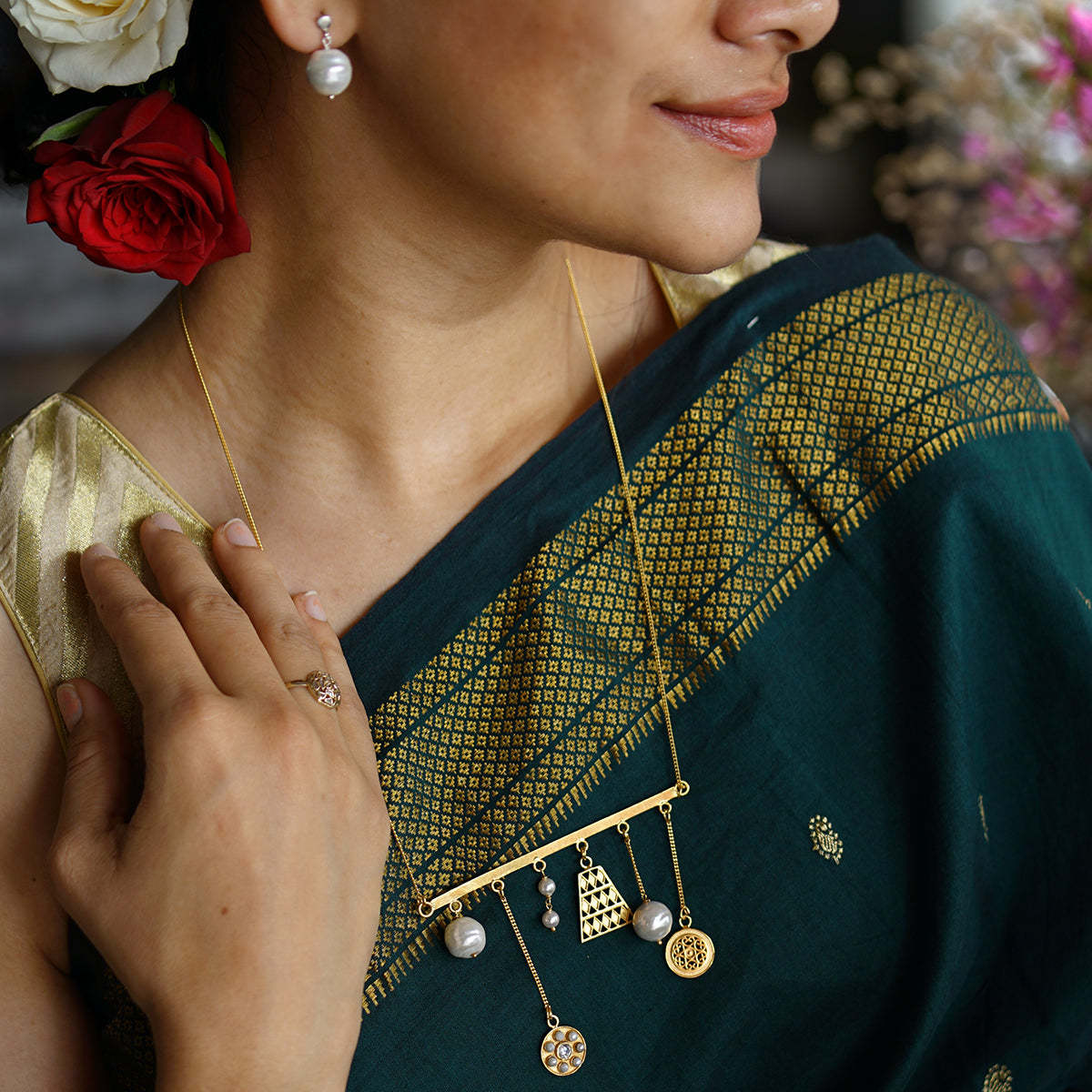 a woman in a green sari with a flower in her hair