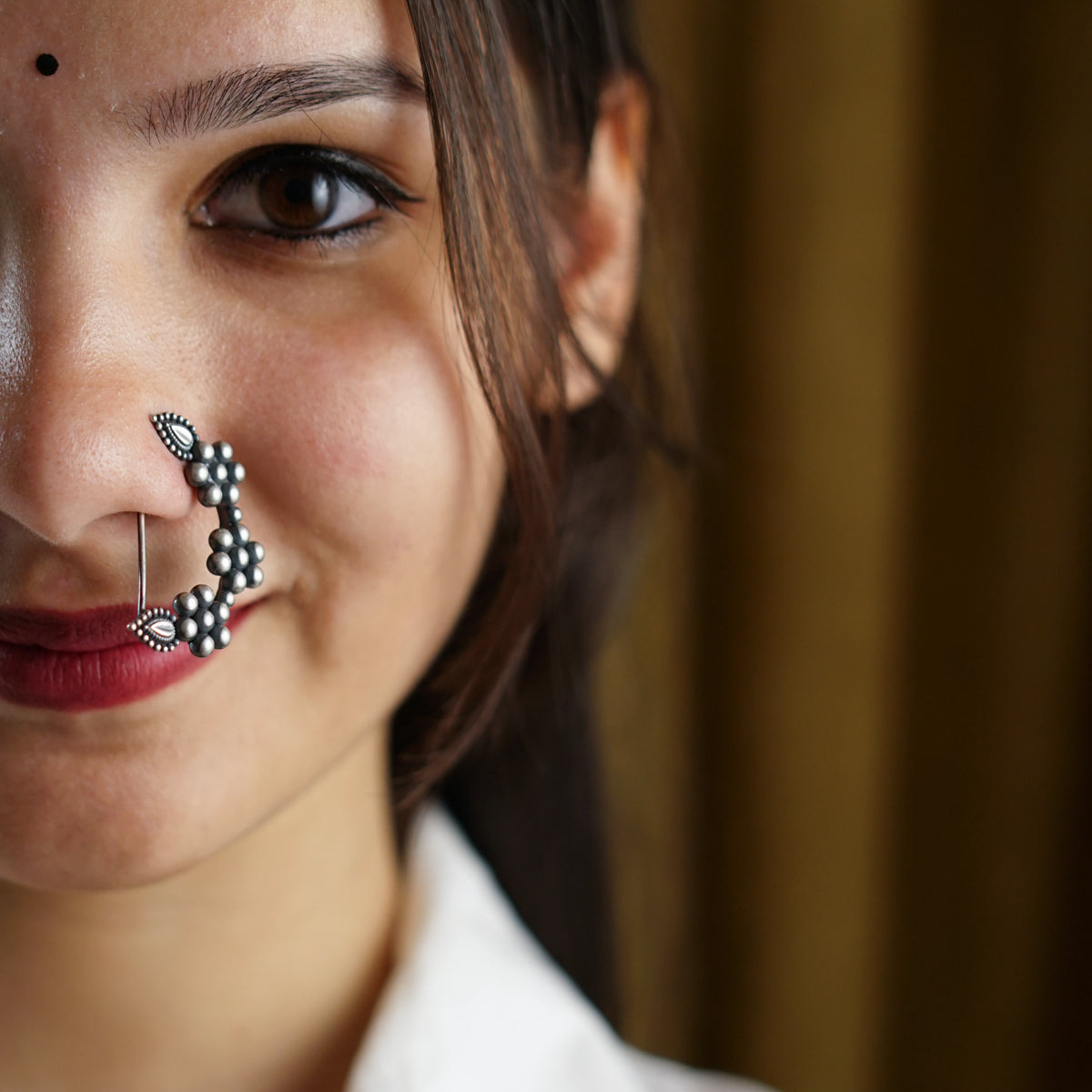 a woman with a nose pin on her nose