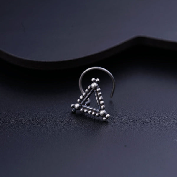 a pair of silver hoop earrings on a black surface