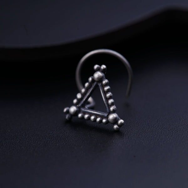 a pair of earrings with a triangle and beads