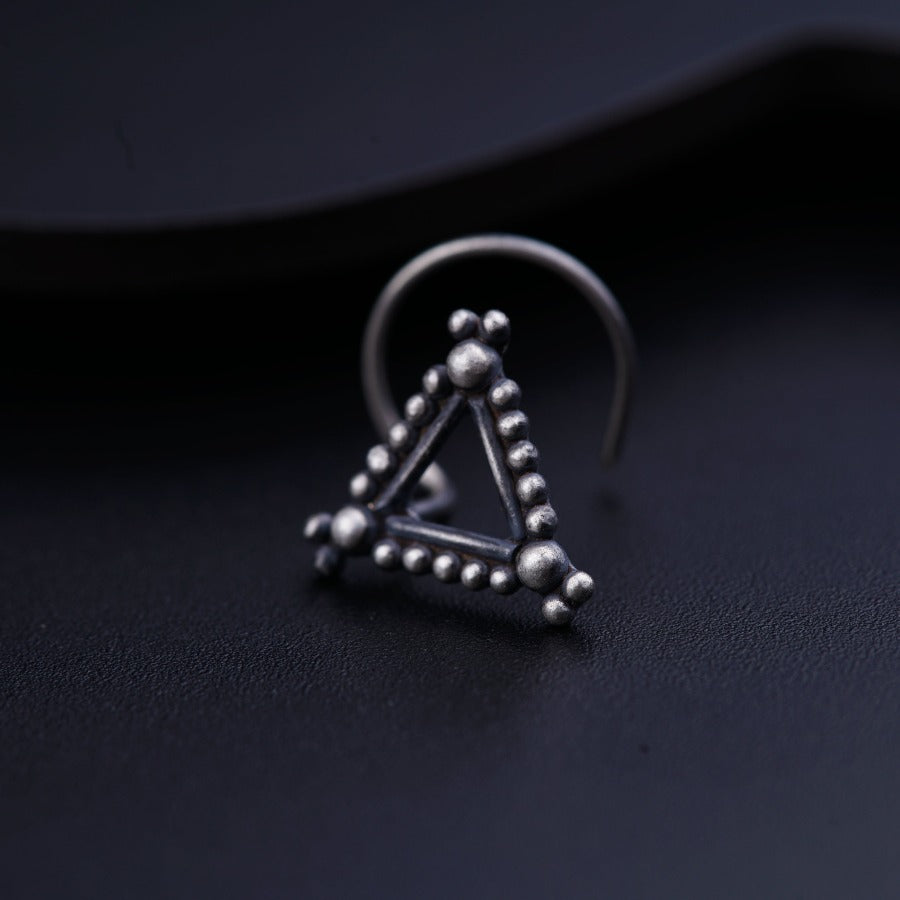 a pair of earrings with a triangle and beads