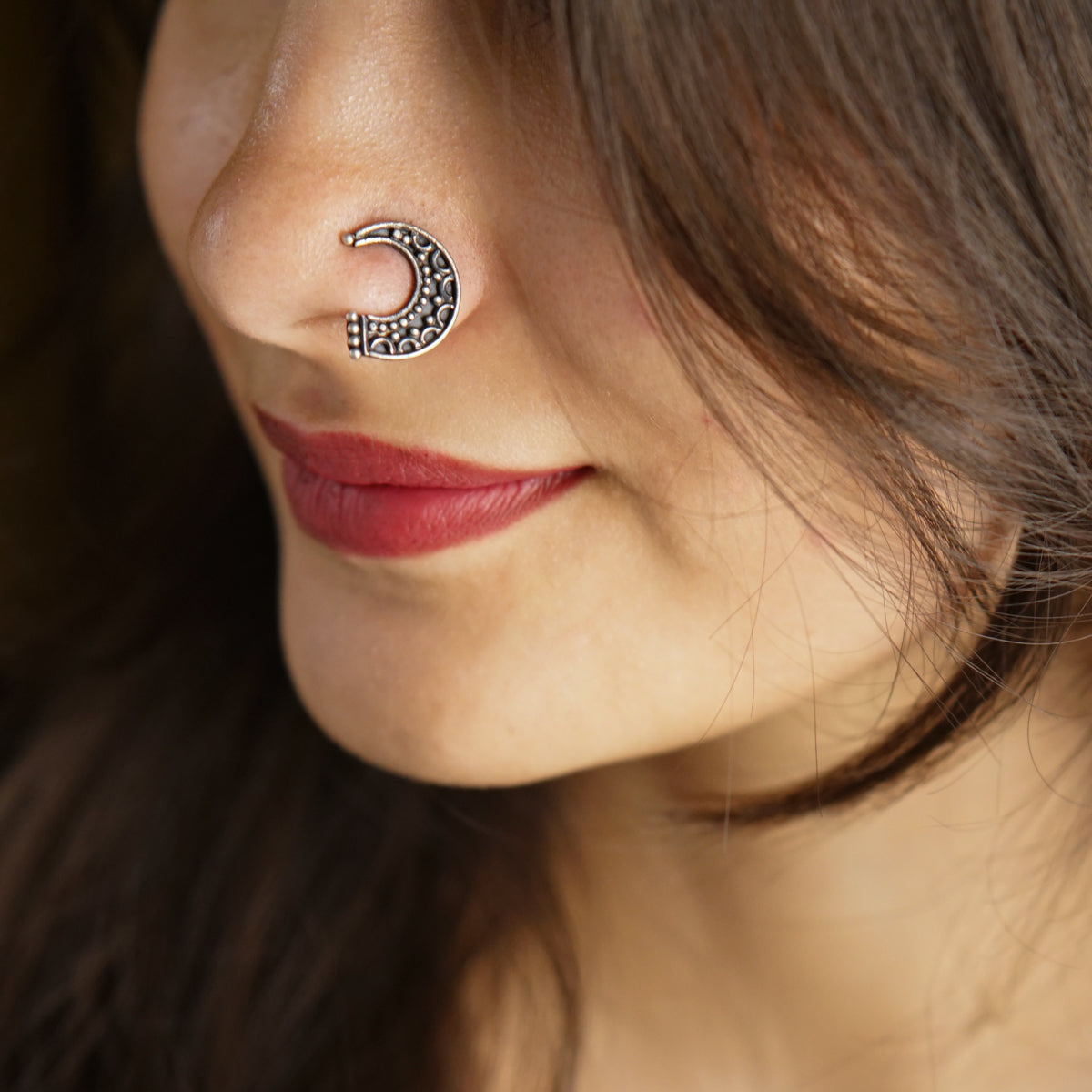 a close up of a person with a nose piercing