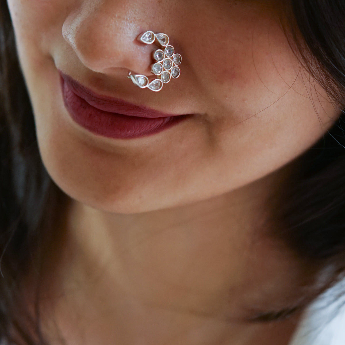a close up of a person with a nose piercing
