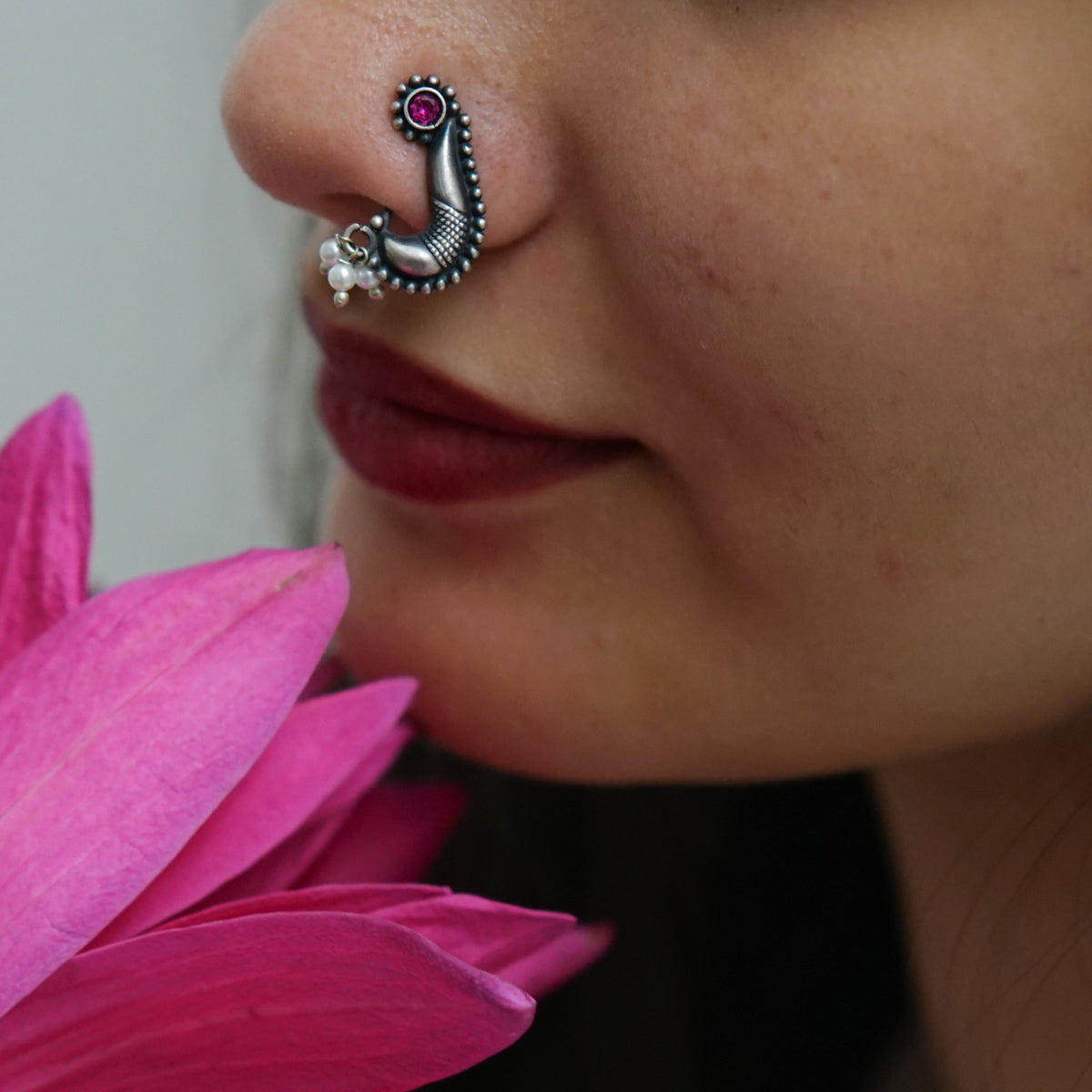 a close up of a person with a nose piercing