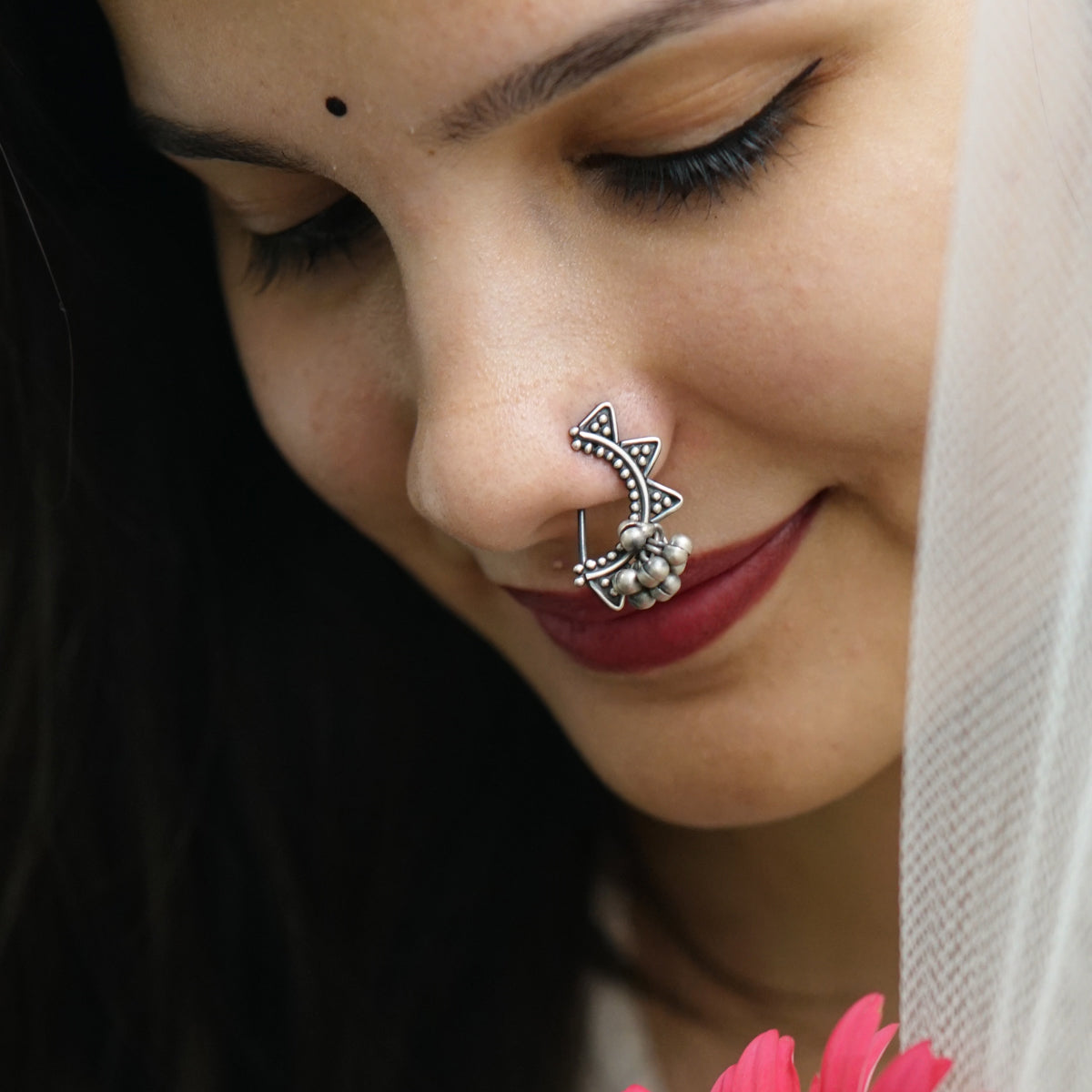 a close up of a woman with a nose piercing