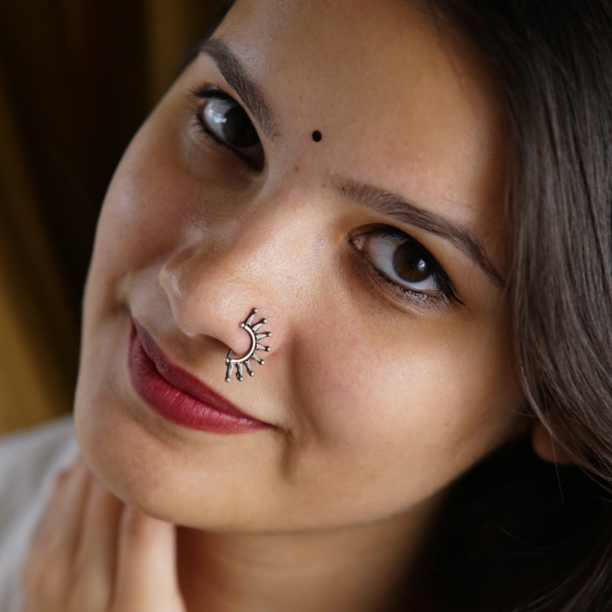 a woman with a nose piercing on her nose