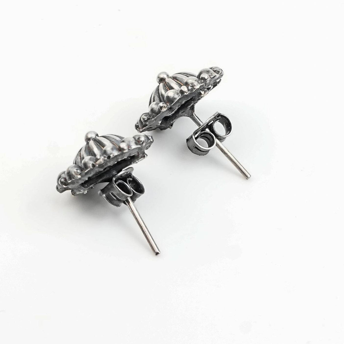 Angled view of Silver Oxidized Dome Earrings in 92.5 sterling silver with a classic dome design