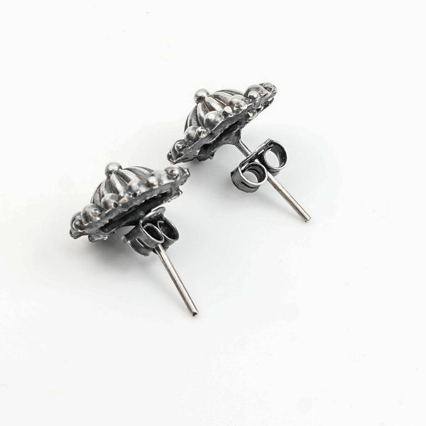 Angled view of Silver Oxidized Dome Earrings in 92.5 sterling silver with a classic dome design